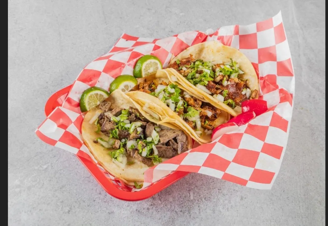 Street tacos in a basket with lime and radish Street tacos in a basket with lime and radish